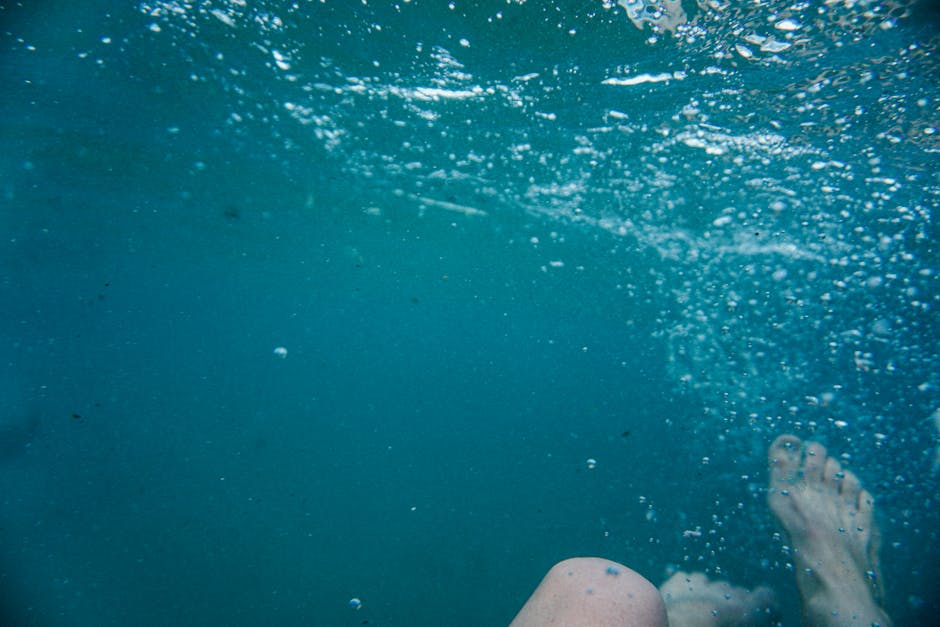 Dynamic underwater shot of a swimmer's legs at Bondi Beach, capturing the serene blue ocean.