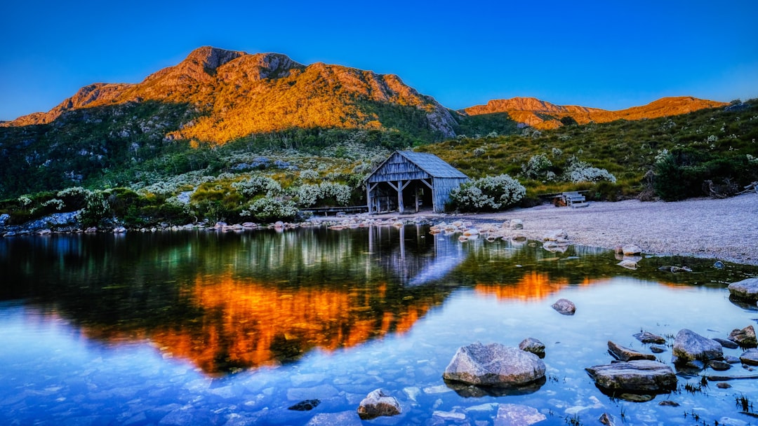The mists clear over the jagged peaks of Cradle Mountain as the sun finally breaks through! 🏔️ Mark your calendars – Cradle Mountain is officially reopening after the festival!