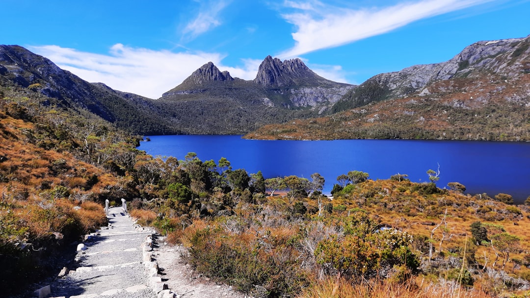 The mists clear over the jagged peaks of Cradle Mountain as the sun finally breaks through! 🏔️ Mark your calendars – Cradle Mountain is officially reopening after the festival!