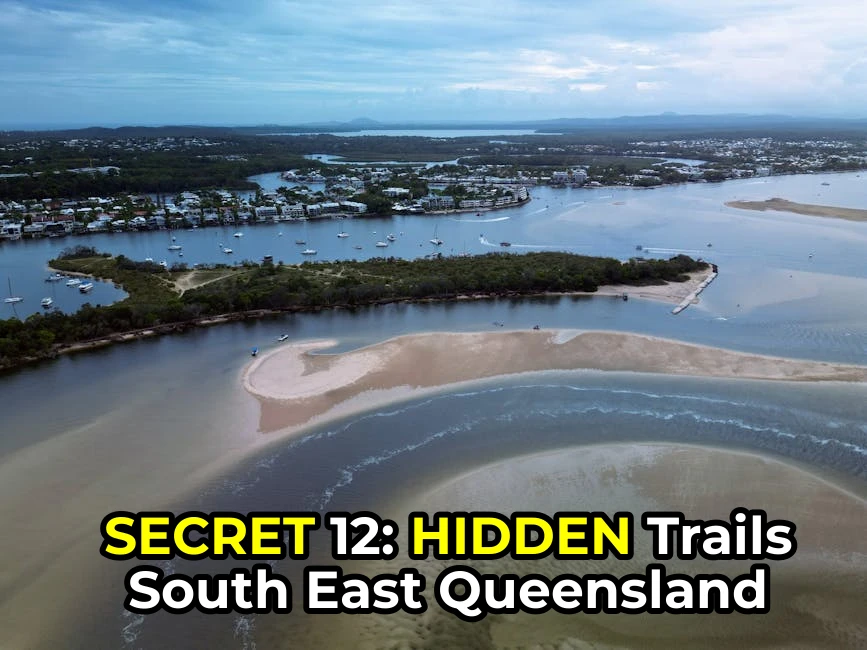 Serene aerial view of Noosa River, showcasing sandbanks, watercraft, and lush greenery.