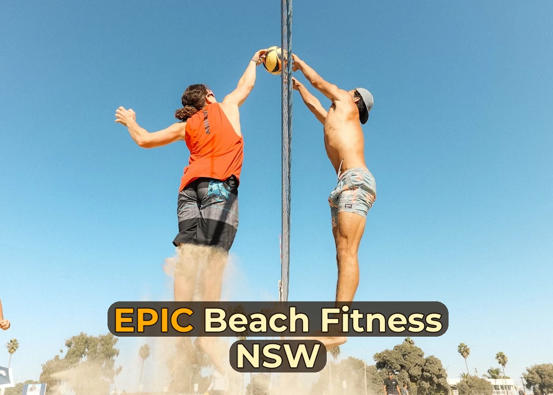 man in orange t-shirt and blue denim shorts holding silver pole during daytime